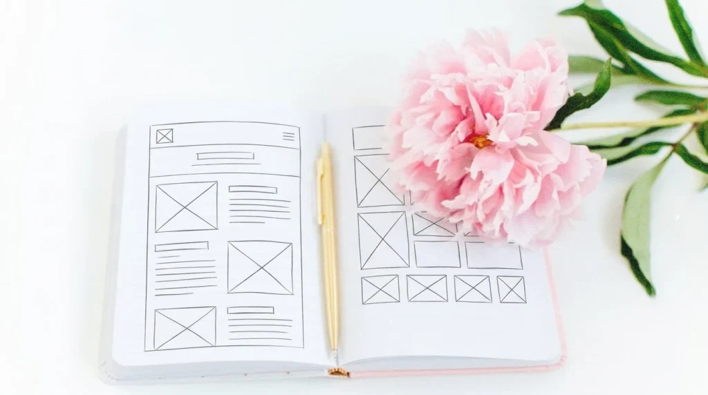 Notebook with a website wireframe for the how to write an about me page guide
