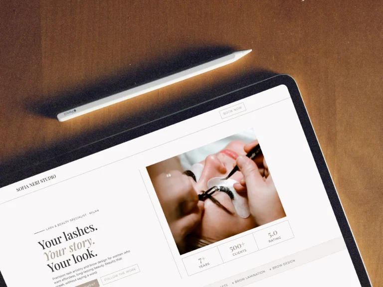 Close-up mockup of an affordable one-page website for a lash artist on a tablet screen next to a white stylus.